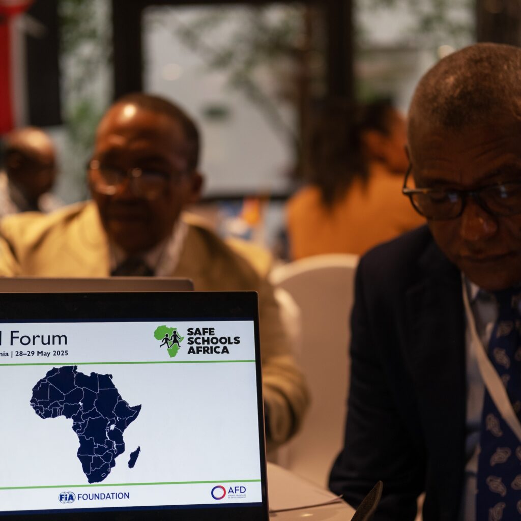 Laptop open on conference table, displaying Safe Schools Africa logo and map of Africa