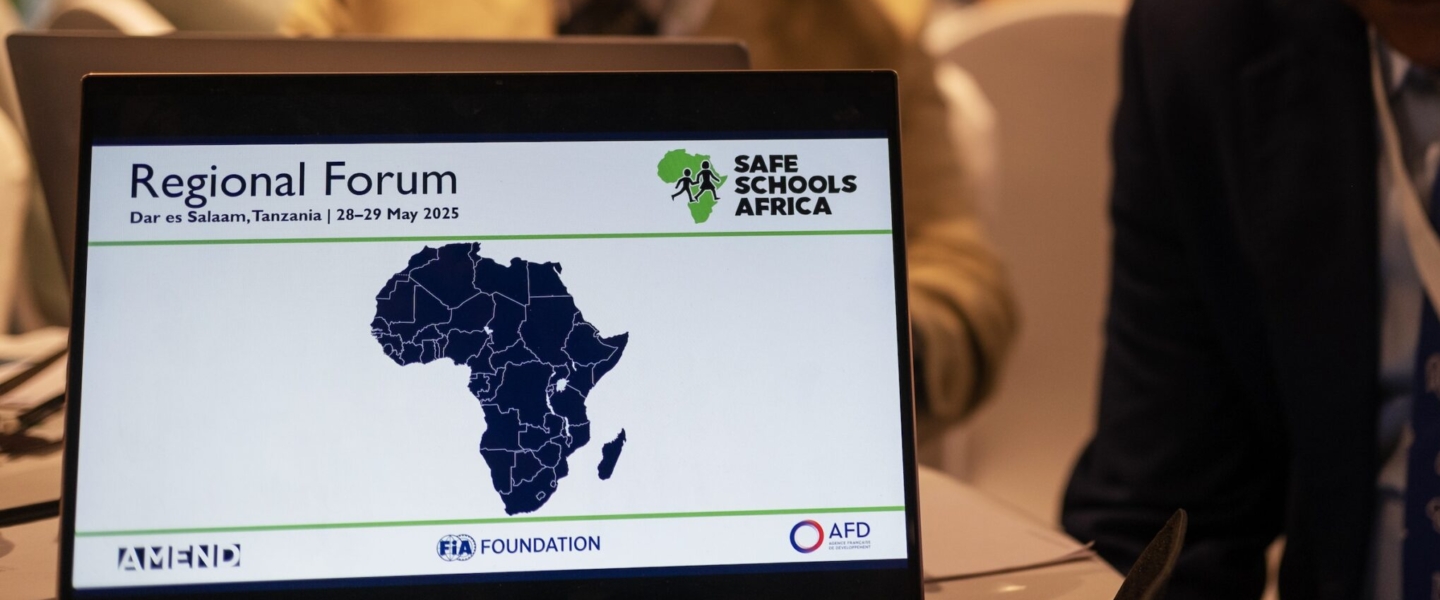 Laptop open on conference table, displaying Safe Schools Africa logo and map of Africa