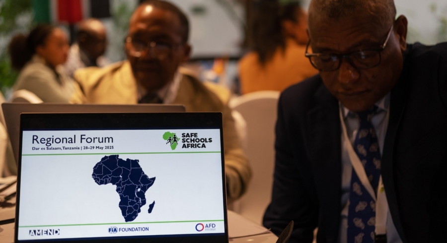 Laptop open on conference table, displaying Safe Schools Africa logo and map of Africa
