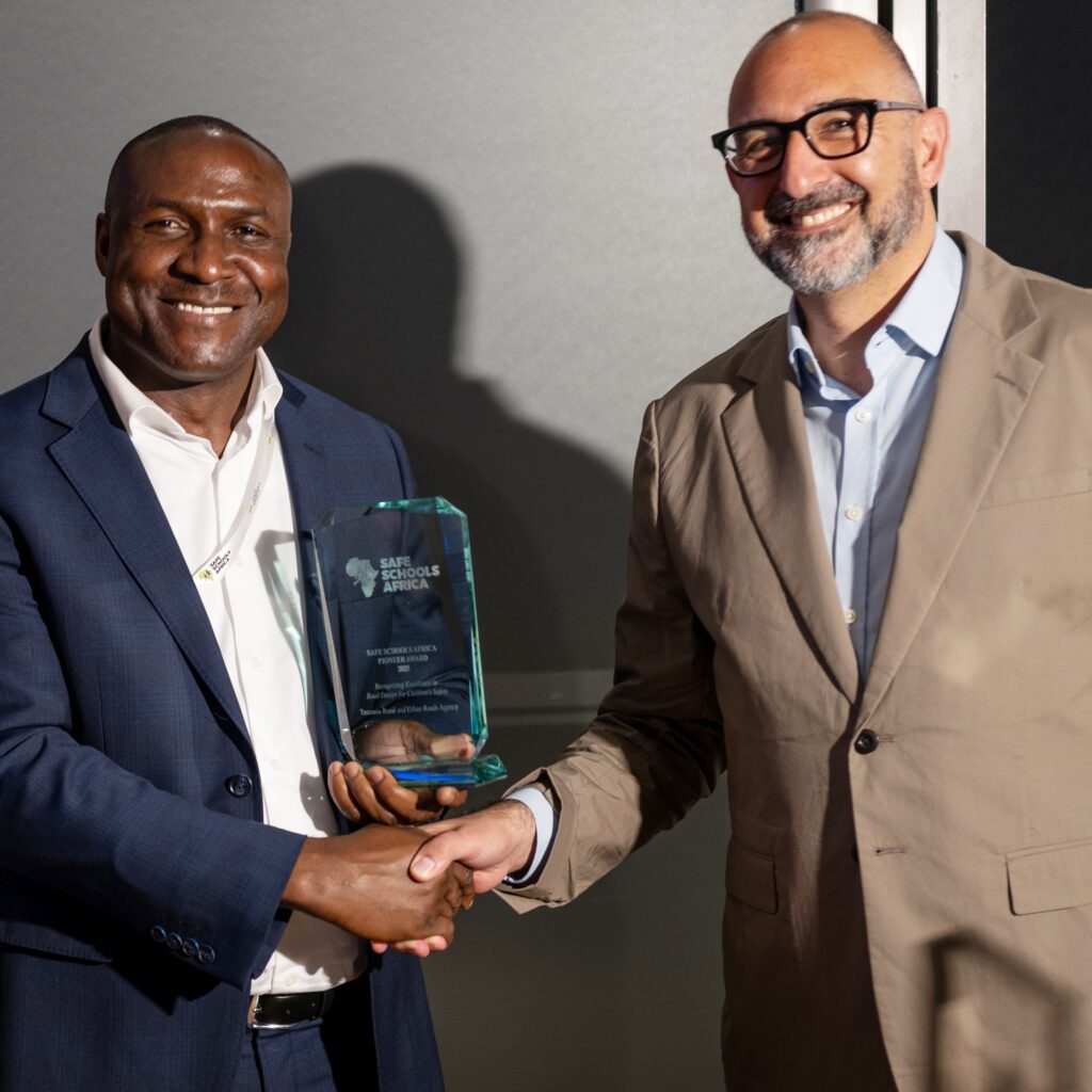 Engineer Humphrey Kanyenye accepting the Safe Schools Africa Pioneer Award on behalf of TARURA from FIA Fondation Executive Director Saul Billingsley